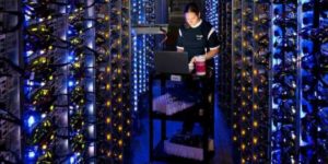 Person working in a back room with several servers